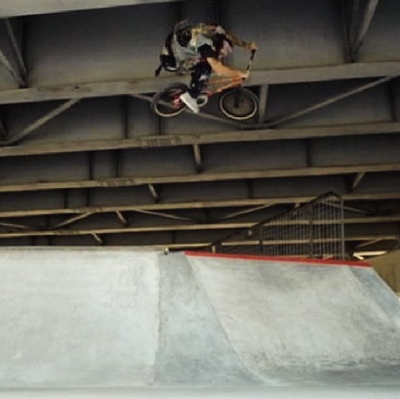BMX air under a bridge